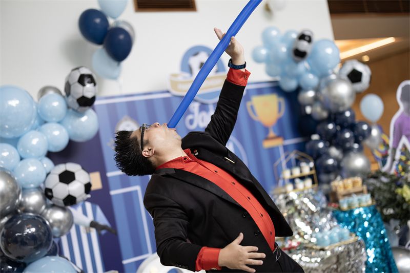 Magician performing at a football themed birthday