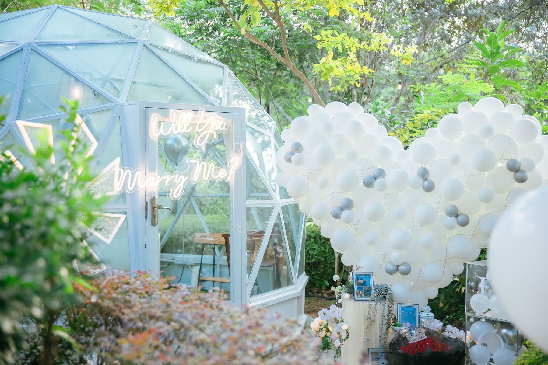 White balloon heart beside a glass garden dome