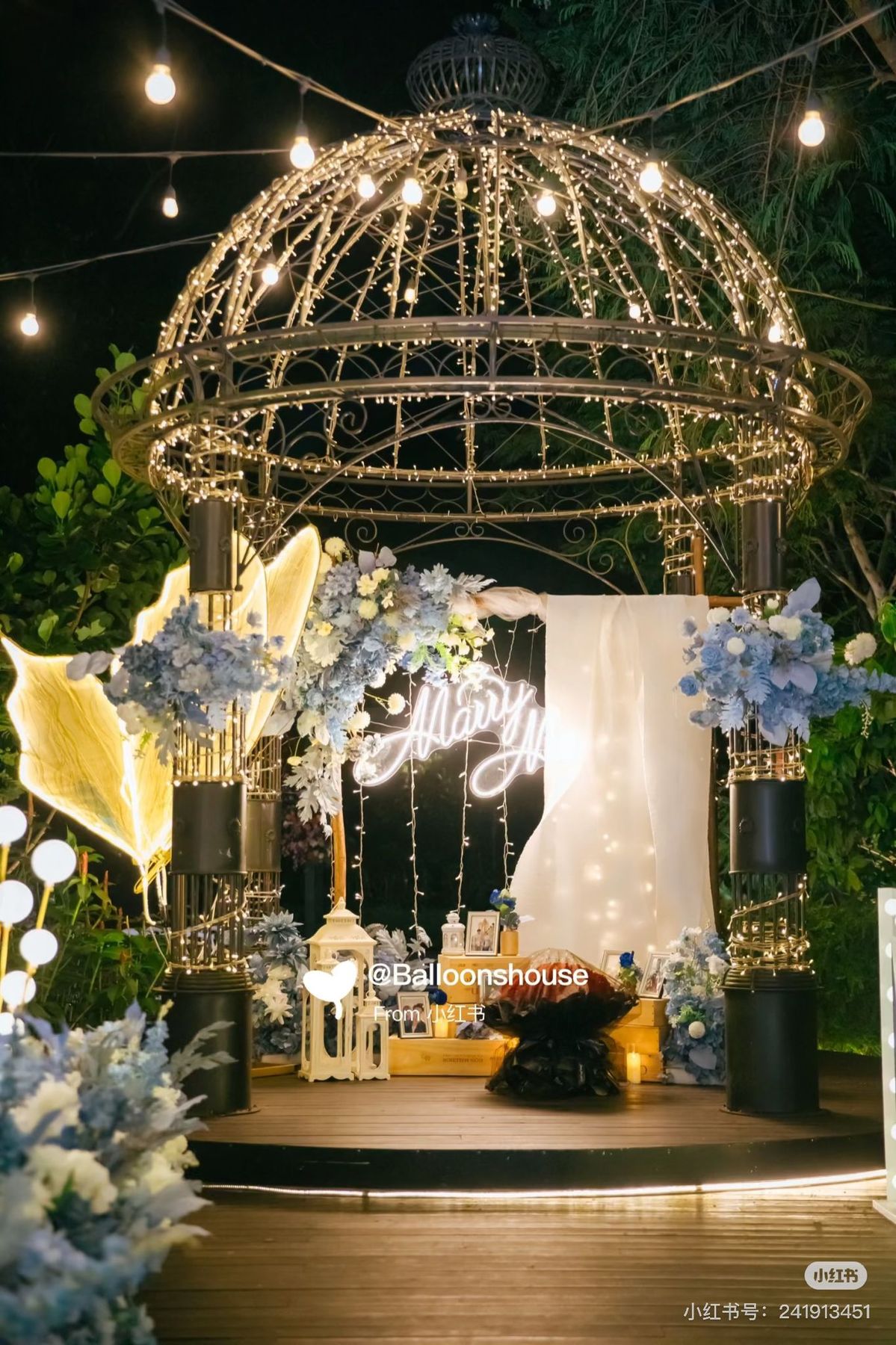 Garden gazebo strung with lights and flowers for a proposal