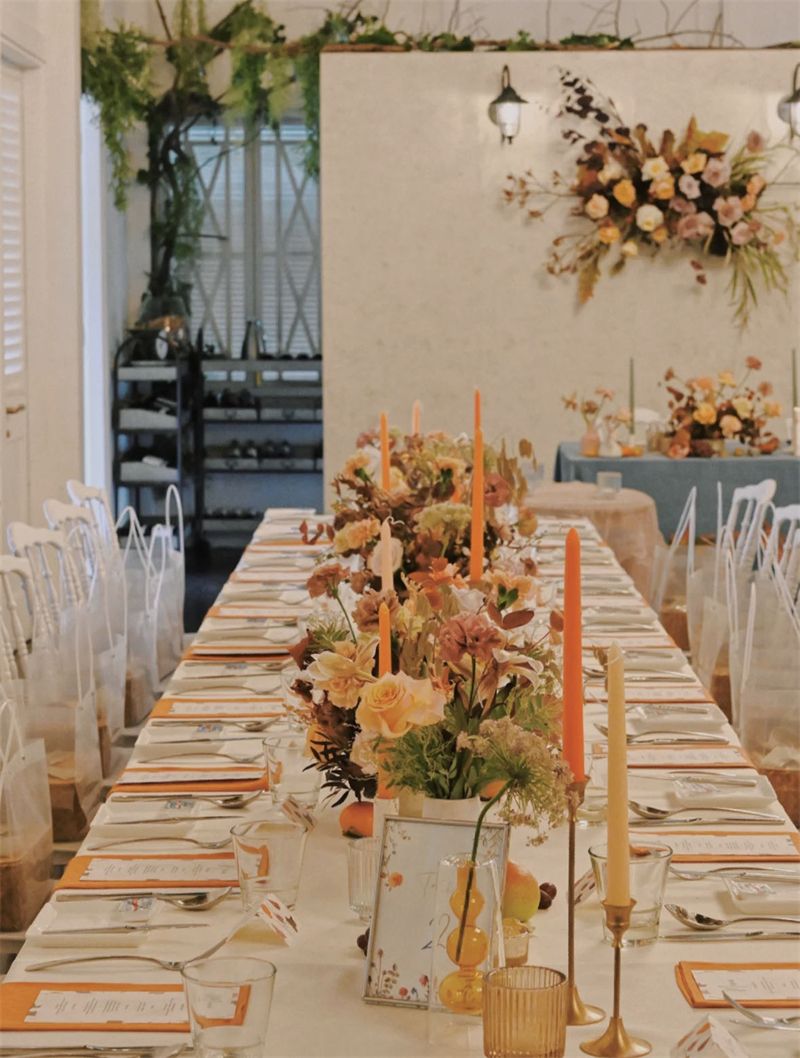 Long wedding table with peach flowers and candles